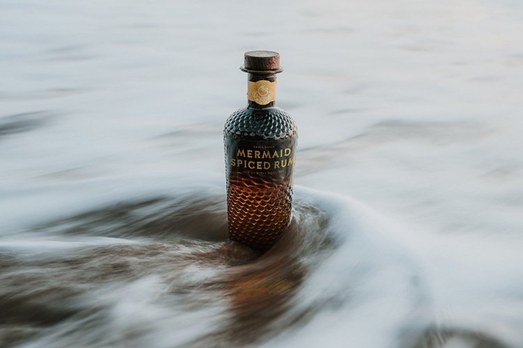 Isle of Wight Distillery - Mermaid Spiced Rum by the ocean